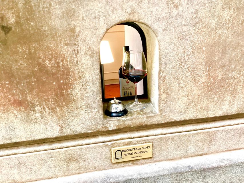 Florence: Wine Windows Walk with Wine Tasting and Appetizers - The operating wine window stop: your glass from a Renaissance façade